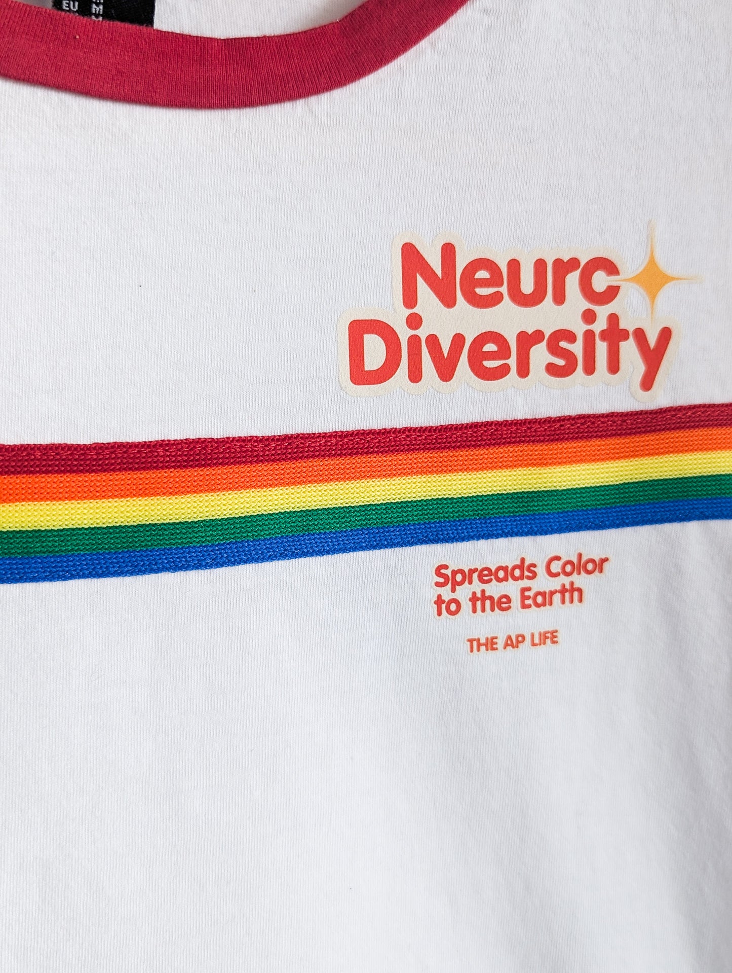 Neurodiversity Spreads Color to the Earth - Women's Rainbow Ringer Baby Tee - Repurposed Rebels